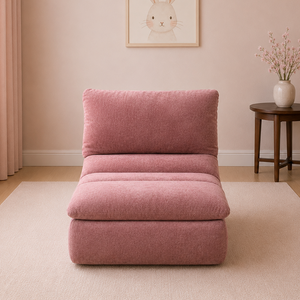 Pink armchair in a room with a rabbit artwork on the wall and a small table with a vase.
